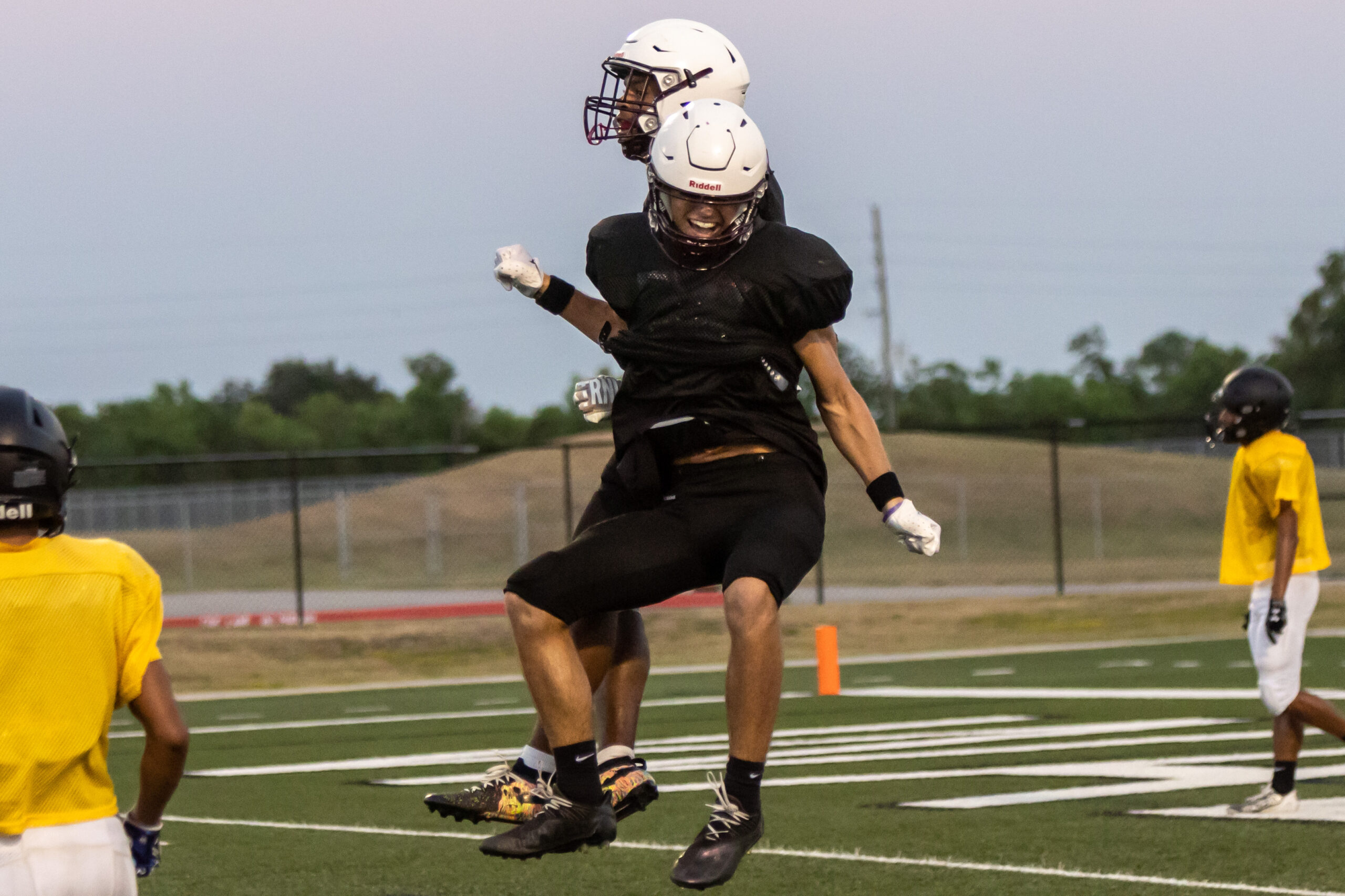 Waller Bulldog varsity hopefuls celebrate a touchdown during the controlled live quarter of the first scrimmage of the year. The Dogs unofficially won the scrimmage, 12-0. The Waller Bulldogs develop their skills and teamwork during the first scrimmage of the year. Waller hosts the second and final scrimmage of the season at Waller ISD Stadium this Thursday at 6 p.m. (photo courtesy RoninVisuals.com)