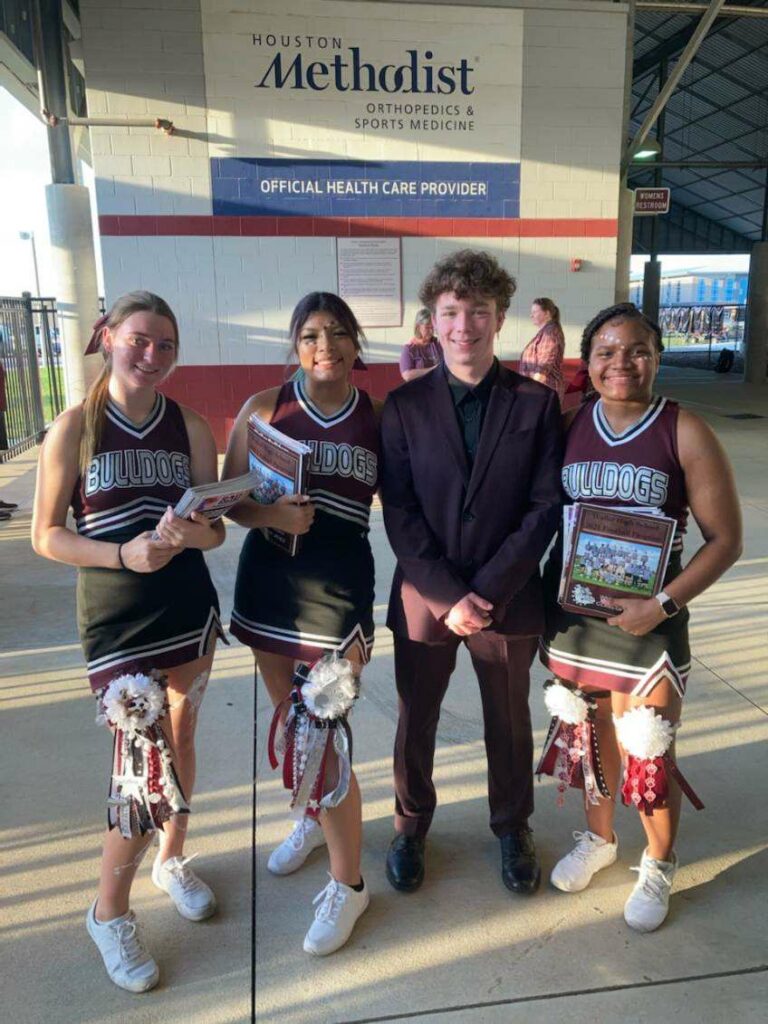 Waller Bulldog cheerleaders sell programs at a home game last season. (photo courtesy Waller Cheer Booster Club)