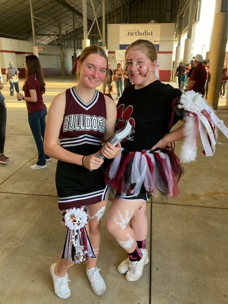 Waller Bulldog cheerleaders sell programs at a home game last season. (photo courtesy Waller Cheer Booster Club)