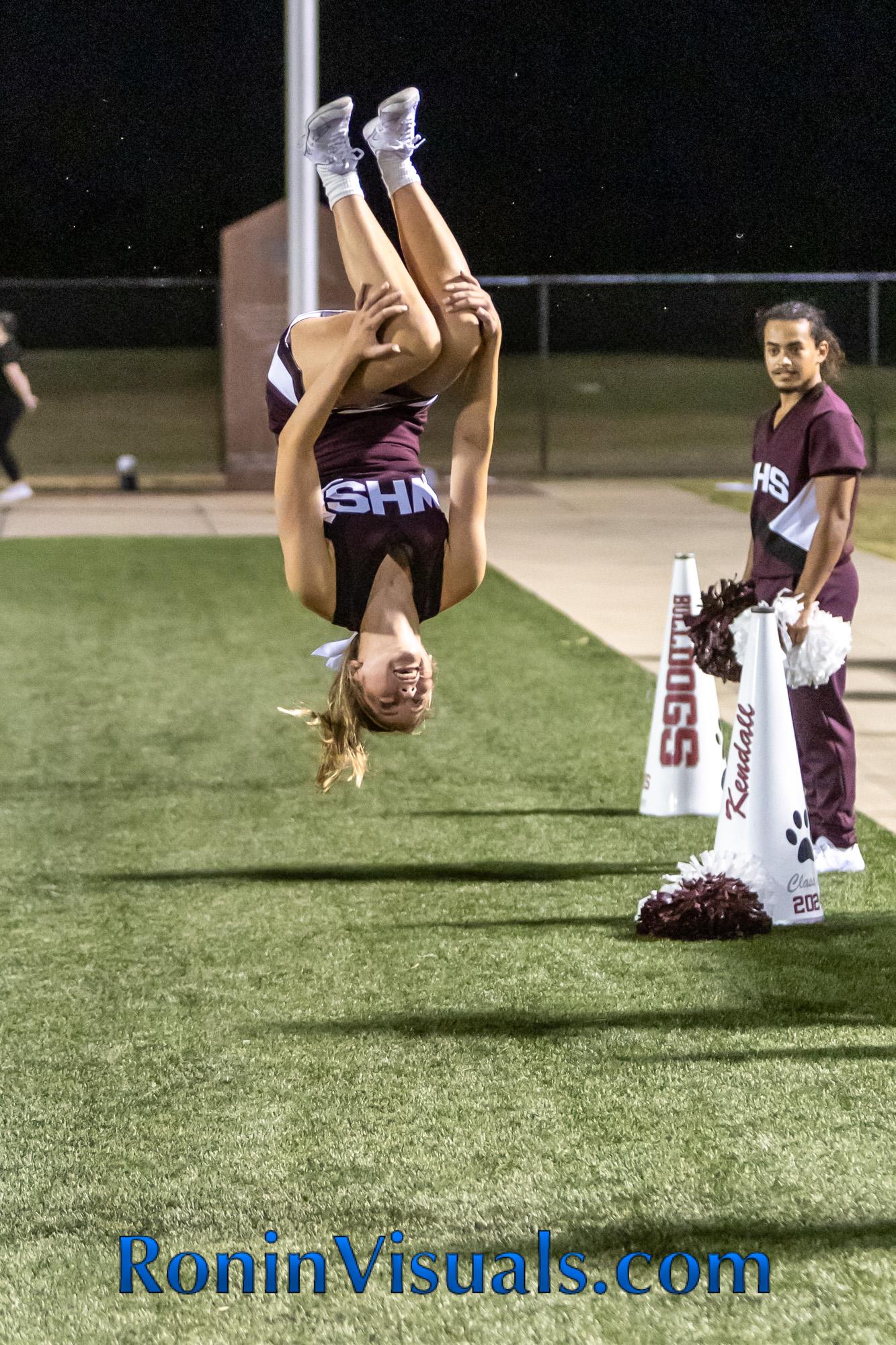 Macy Moffitt, a varsity cheerleader, backflips on the sidelines of the season opener last Friday night. The Waller Bulldog varsity team battles the Bryan Vikings, with the 21-6 decision favoring the Vikings. The Bulldogs next game will be against Mayde Creek in Katy ISD's Legacy Stadium. (photo courtesy RoninVisuals.com)