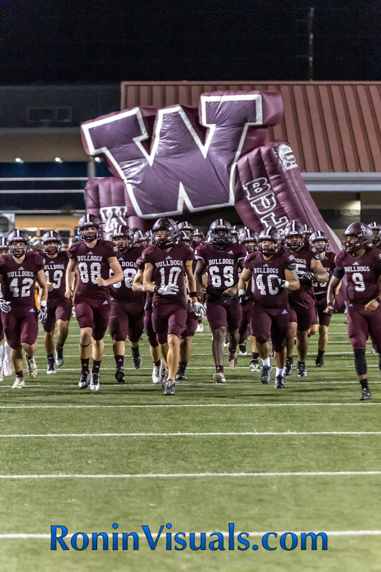 The Waller Bulldogs take the field in the second half. The Waller Bulldog varsity team battles the Bryan Vikings, with the 21-6 decision favoring the Vikings. The Bulldogs next game will be against Mayde Creek in Katy ISD's Legacy Stadium. (photo courtesy RoninVisuals.com)