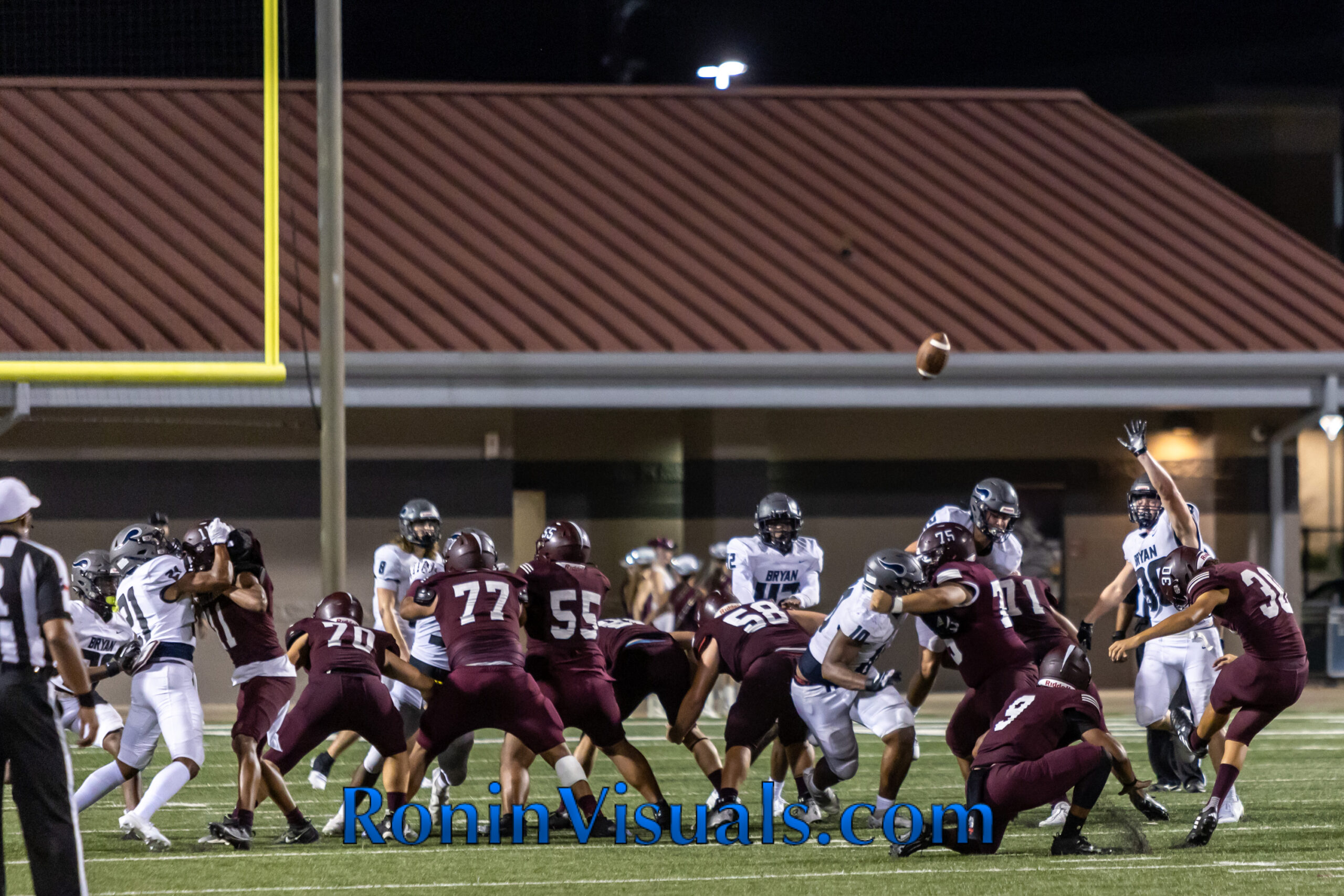 Joevan Ortiz (30) splits the uprights for his second field goal of the night, held by Jordan Duncan (9). The Waller Bulldog varsity team battles the Bryan Vikings, with the 21-6 decision favoring the Vikings. The Bulldogs next game will be against Mayde Creek in Katy ISD's Legacy Stadium. (photo courtesy RoninVisuals.com)