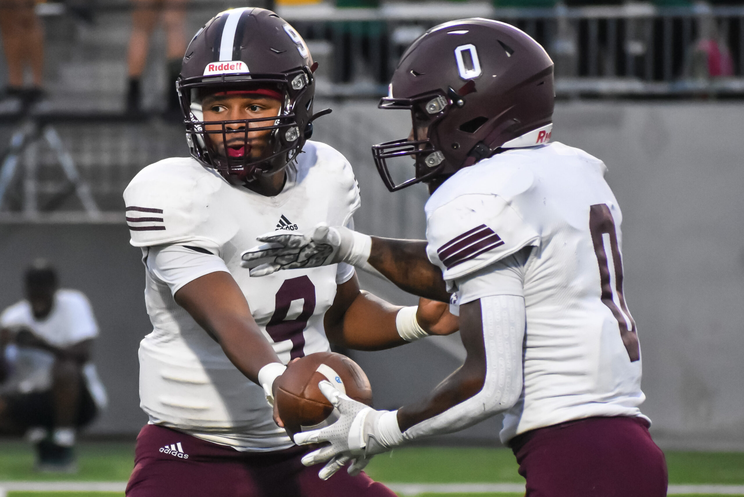 Quarterback Jordan Duncan (9) hands the ball to Alex Barrs (0) during the Bulldogs' second game of the season, at Katy ISD's Legacy Stadium. The Waller Bulldogs defeat the Mayde Creek Rams, 35-0, in the second game of the 2023 season. (photo by Antony Blalock, special to the WallerNews.com from TXHSFB.net)